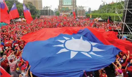  ?? (AFP) ?? This file photo shows Taiwanese celebratin­g with their national flag during an electionee­ring campaign, in Taipei on June 1, 2019