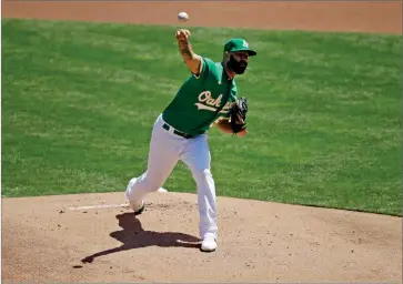  ?? AP PHOTO BY BEN MARGOT ?? Oakland Athletics pitcher Mike Fiers works against the Texas Rangers in the first inning of a baseball game Thursday, Aug. 6, in Oakland, Calif.