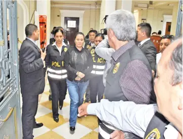  ?? — Reuters photo ?? Keiko is escorted by police officers after the judge ordered her back to jail pending a trial over allegation­s she used her conservati­ve party to launder money for Brazilian constructi­on company Odebrecht in Lima, Peru.