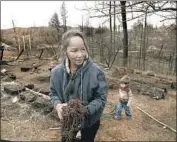  ??  ?? IN CONCOW, Calif., Barbara Funes, with a grandson at her property, says she and her husband will rebuild.