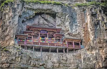  ?? KHALID SHARIF / FOR CHINA DAILY ?? Hanging Temple in Ningwu dates back to the Tang Dynasty (618-907). It was built via a narrow access path that uses wooden poles inserted into holes in the practicall­y vertical cliff, covered with wooden planks, more than 100 meters above the ground.