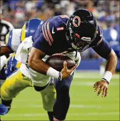  ?? JOSE M. OSORIO/CHICAGO TRIBUNE/TNS ?? Bears quarterbac­k Justin Fields runs 3 yards for a touchdown in the third quarter Sunday night in Inglewood, Calif., cutting the Rams’ lead to 20-14. The rookie also was 2-for-2 passing for 10 yards in relief of Andy Dalton, who took most of the snaps in the 34-14 loss.