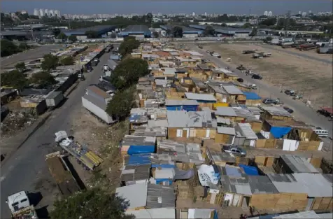  ?? Andre Penner/Associated Press ?? Shacks fill the Jardim Julieta favela in Sao Paulo, Brazil, Thursday. The coronaviru­s had just hit the city when this parking lot for trucks became a favela, with dozens of shacks. Since the first wave of residents in mid-March, hundreds of families joined, with most having been evicted during the pandemic.