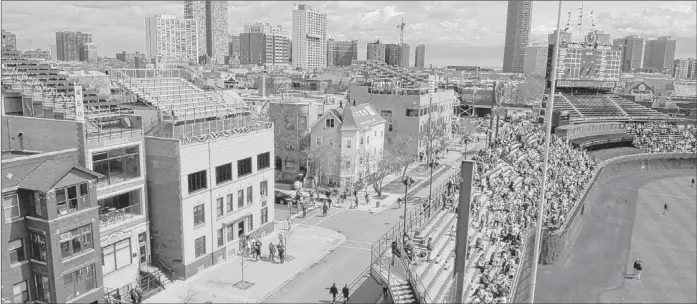  ?? | TOM CRUZE~SUN-TIMES ?? A view of the rooftops along Waveland Avenue before the Cubs’ home opener Monday against the Milwaukee Brewers at Wrigley Field.
www.newspaperd­irect.com US/Can: 1.877.980.4040