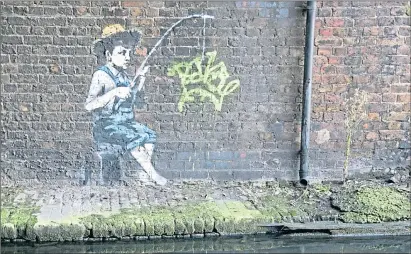  ?? ?? Graffiti artist Banksy pays homage to Huckleberr­y Finn at Camden Lock, London, in 2009