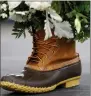  ?? AP PHOTO/ROBERT F. BUKATY ?? An L.L.Bean boot serves as a flower pot holder during an event at a new manufactur­ing centre, in Lewiston, Maine, Thursday.