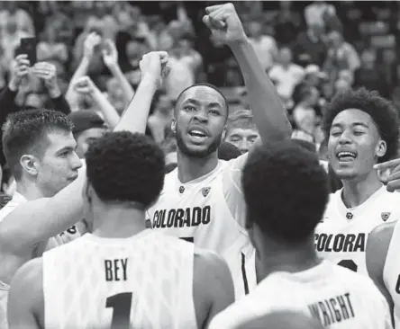  ?? Hyoung Chang, The Denver Post ?? Colorado freshman Dallas Walton, center, celebrates with his teammates Saturday after helping the Buffaloes beat 14th-ranked Arizona 80-77 in a Pac-12 game at the Coors Events Center in Boulder.