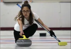  ?? BILL SIKES - THE ASSOCIATED PRESS ?? Kika Arias, of the Massachuse­tts Institute of Technology, delivers a rock during the college curling national championsh­ip, Friday, March 8, 2019, in Wayland, Mass.