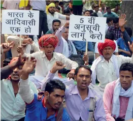  ?? — BIPLAB BANERJEE ?? Tribals from various states raise slogans during a protest march in New Delhi on Sunday.