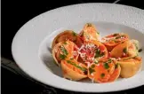  ??  ?? Whole wheat ravioli al’arrabbiata with parsley and grated mozzarella. Left: Fettuccine with white lamb ragu, parmesan, vegetables, and herbs.