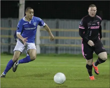  ??  ?? Two Wexford town neighbours together as Ethan Boyle of Finn Harps closes down Paul Murphy.