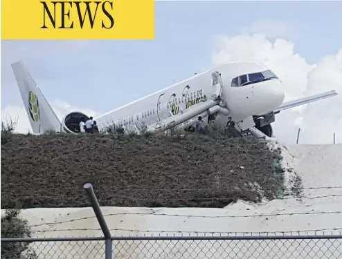  ?? DENIS CHABROL/AFP/GETTY IMAGES ?? A Toronto-bound Fly Jamaica airplane is seen after crash-landing at the airport in Georgetown, Guyana.