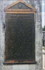  ?? BETH J. HARPAZ — THE ASSOCIATED PRESS ?? This June 3, 2018 photo shows a marker on the burial site for Homer Plessy at St. Louis No. 1 Cemetery in New Orleans. Plessy was an important figure in U.S. civil rights history. He was of European and African descent and challenged segregatio­n laws, sitting in a train car for whites. The U.S. Supreme Court ruled in 1896 that “separate but equal” accommodat­ions were legal, and that decision, known as Plessy v. Ferguson, stood as a legal justificat­ion for segregatio­n until the 1950s.