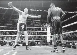  ?? Harry How Getty Images ?? TYSON FURY taunts Deontay Wilder, who dropped Fury twice in their heavyweigh­t title fight at Staples Center but couldn’t finish him. It ended in a draw.