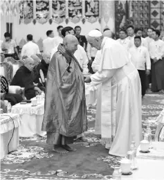  ??  ?? Francis shakes hands with Kumarabhiv­amsa during a meeting in Yangon. — Reuters photo