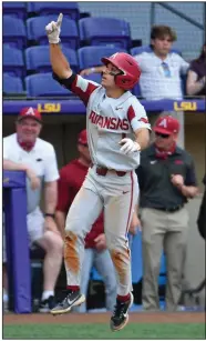  ?? (The Advocate/Hillary Scheinuk) ?? Arkansas second baseman Robert Moore celebrates after hitting his 11th home run of the season Saturday against LSU at Alex Box Stadium in Baton Rouge. Moore’s home run came in a seven-run fifth inning that helped the Razorbacks defeat the Tigers 17-10 in the first game of a doublehead­er.