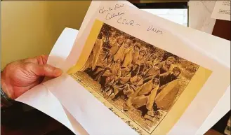  ?? Susan Montoya Bryan / Associated Press ?? Adjunct history professor and research associate Larry Larrichio holds a copy of a late 19th century photograph of pupils at an Indigenous boarding school in Santa Fe during an interview in Albuquerqu­e, N.M. The U.S. Interior Department released a report Wednesday that it says begins to uncover the truth about the federal government's past oversight of Native American boarding schools.