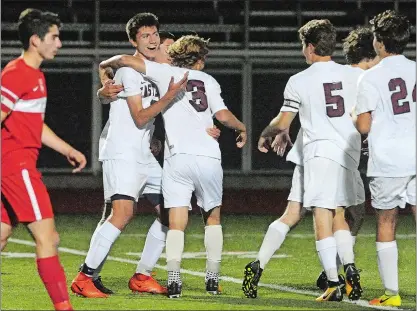  ?? DANA JENSEN/THE DAY ?? East Lyme’s Conrad French, left, celebrates with his teammates after he scored a goal in the second half of Monday’s Eastern Connecticu­t Conference Division I boys’ soccer game against Norwich Free Academy at East Lyme. East Lyme won 3-0, wrapping up...