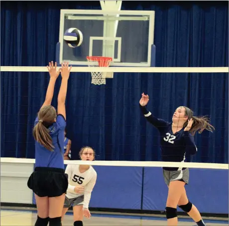  ??  ?? Gordon Lee Middle School’s Emoree Rogers puts a shot over the outstretch­ed arms of a Ringgold player, while Lady Trojans libero Mary Kate Roberts looks on. Gordon Lee swept the match and entered the new week with a perfect 7-0 league mark. (Messenger...