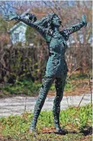  ?? ?? A statue along the driveway depicts a woman throwing her arms out as if she just won a race. It’s at the home of Kathleen Stanislaws­ki and Frank Paul in Muskego.