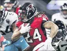  ?? DANNY KARNIK — THE ASSOCIATED PRESS ?? Former Atlanta Falcons running back Devonta Freeman (24) runs against the Jacksonvil­le Jaguars during a game last season.