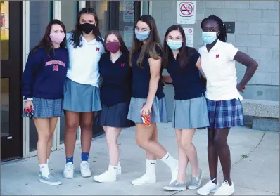  ?? Photos by Joseph B. Nadeau ?? A group of Mount Saint Charles Academy students were wearing their protective masks as they arrived to help out with Monday’s new student orientatio­n program. From left are Sophie Staelen of North Smithfield, Tailia Fernandez of Cumberland, Lauren Vito of Grafton, Kelsey Alves of North Smithfield, Sydney Senerchia of Smithfield and Binta Marong of Pawtucket.