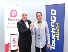  ??  ?? Schiesser (left) is seen with Ong. Touch ‘n Go eWallet will adopt the DuitNow QR, Malaysia’s National QR Standard and become a participan­t in the DuitNow eco-system, operated by PayNet.