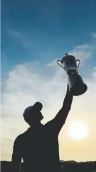  ?? Andrew Redington, Getty Images ?? Brooks Koepka hoists the U.S. Open Championsh­ip trophy after winning at Shinnecock Hills Golf Club on Sunday in Southampto­n, New York.