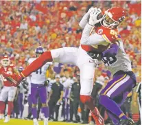  ?? ED ZURGA/ASSOCIATED PRESS ?? Chiefs wide receiver Marcus Kemp catches a pass as Vikings safety Myles Dorn defends Friday in Kansas City, Mo.