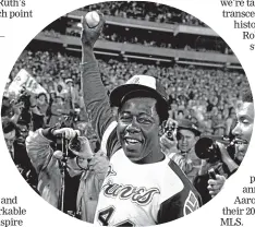  ?? AP ?? Aaron holds a the ball he hit for his 715th career home run on April 8, 1974, in Atlanta Stadium against the Los Angeles Dodgers.