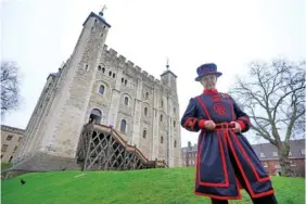  ?? AP PHOTO/KIRSTY WIGGLESWOR­TH ?? Barney Chandler, newly appointed ravenmaste­r at The Tower of London in London, poses Thursday in front of the 1,000-year-old fortress.