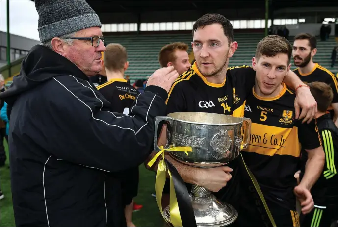  ?? Photo by Brendan Moran/Sportsfile ?? Daithí Casey, centre, and David O’Leary of Dr. Crokes celebrate with the Bishop Moynihan Cup after the Kerry County Senior Football Championsh­ip Final match between Dr. Crokes and South Kerry at Austin Stack Park, Tralee in Kerry