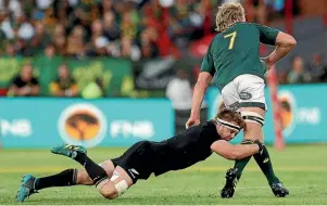  ??  ?? Sam Cane tackles Springbok Pieter-Steph du Toit before being forced from the field in Pretoria on Sunday. THEMBA HADEBE/AP