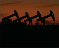  ?? (AP/Eric Gay) ?? Pump jacks operate at dusk in an oil field near Barnes City, Texas, in November.