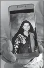  ?? AP/FAREED KHAN ?? “She was a great soul,” Aziz Sheikh said Saturday of his daughter Sabika. He shows her picture on a phone at their home in Islamabad.