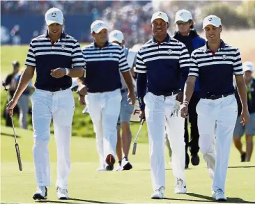  ??  ?? Ready for battle: The American team (from left) Jordan Spieth, Patrick Reed, Tiger Woods and Justin Thomas walk to the 18th green during a practice round at Le Golf National in SaintQuent­in-en-Yvelines, outside Paris yesterday. — AP