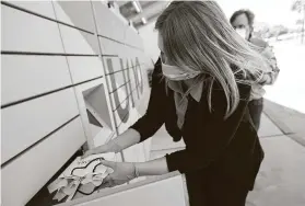  ?? Yi-Chin Lee / Staff photograph­er ?? Uno Manager Kerri Collier puts customer's online orders into pickup lockers at Memorial City Mall.