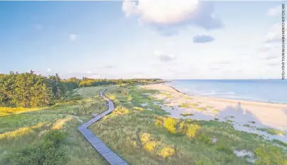  ??  ?? Ein Bohlenweg führt in Nieblum auf der Insel Föhr bis an den Strand.