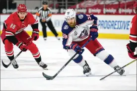  ?? BROOME / AP GERRY ?? Defenseman David Savard (right) skates for the Columbus Blue Jackets against Carolina Hurricanes center Martin Necas during the first period of a game in Raleigh, N.C. The defending Stanley Cup champion Tampa Bay Lightning acquired Savard from the Blue Jackets in a three-team trade Saturday that also involves the Detroit Red Wings. Savard had played in nearly 600 games in 10 seasons with Columbus.