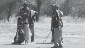  ??  ?? ZPCS Commission­er-General Paradzai Zimondi (right) closely follows an onflight ball at Harry Allen Golf Club yesterday