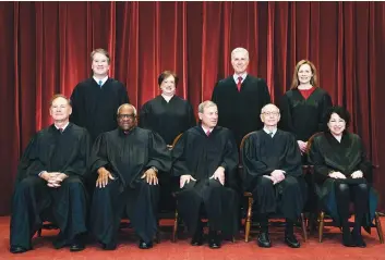  ?? Associated Press ?? ■ In this April 23 file photo, members of the Supreme Court pose for a group photo at the Supreme Court in Washington. Seated from left are Associate Justice Samuel Alito, Associate Justice Clarence Thomas, Chief Justice John Roberts, Associate Justice Stephen Breyer and Associate Justice Sonia Sotomayor, while standing from left are Associate Justice Brett Kavanaugh, Associate Justice Elena Kagan, Associate Justice Neil Gorsuch and Associate Justice Amy Coney Barrett.