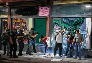  ?? Matthew Busch / Contributo­r file photo ?? People are shot point-blank with pepper balls by police downtown on Houston Street after the Mar Imports jewelry store was looted at the end of May.