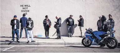  ?? ROBERTO E. ROSALES/JOURNAL ?? People gather in front of actor Shia LaBeouf’s 24-hour live-streaming camera in Downtown Albuquerqu­e on Monday.