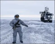  ?? AP/VLADIMIR ISACHENKOV ?? A Russian soldier (left) guards a mobile air defense system on Kotelny Island, between the Laptev Sea and the East Siberian Sea. At right, NATO soldiers take part in exercises in the Canadian Arctic to test readiness against Russian forces.