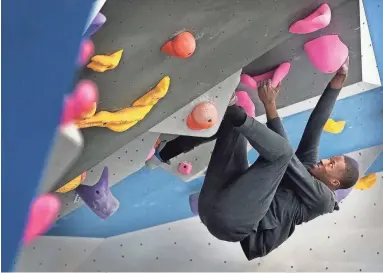  ??  ?? Aaron Anderson struggles up one of over 300 ascent paths at Memphis Rox Climbing, a multi-million dollar indoor climbing gym and community center which is slated to open April 3 at Memphis Mountainto­p Media across the street from Stax Museum of American Soul Music. PHOTOS BY JIM WEBER / THE COMMERCIAL APPEAL