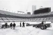  ??  ?? Stadium personnel have had a busy weekend removing snow from the site of Sunday’s NFC title game. Jeff Siner, The Charlotte Observer