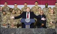  ?? AP ?? President Donald Trump with Afghan President Ashraf Ghani and Joint Chiefs Chairman Gen. Mark Milley, behind him at right, addresses members of the military during a surprise Thanksgivi­ng Day visit at Bagram Air Field.