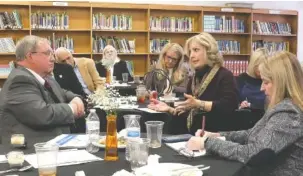  ?? STAFF PHOTO BY TIM BARBER ?? Steve Highlander, left, listens as state Rep. Patsy Hazlewood raises a question to Hamilton County School board members Tuesday in a meeting at Orchard Knob Middle School.