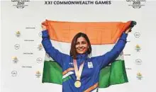  ?? PTI ?? Indian shooter Heena Sidhu holds the Indian flag during the medal ceremony after winning the 25-metre gold.