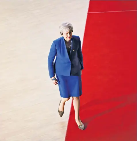  ??  ?? Theresa May cuts a lonely figure as she arrives at the Europa building in Brussels. EU leaders were attending an emergency summit to discuss a new Brexit extension